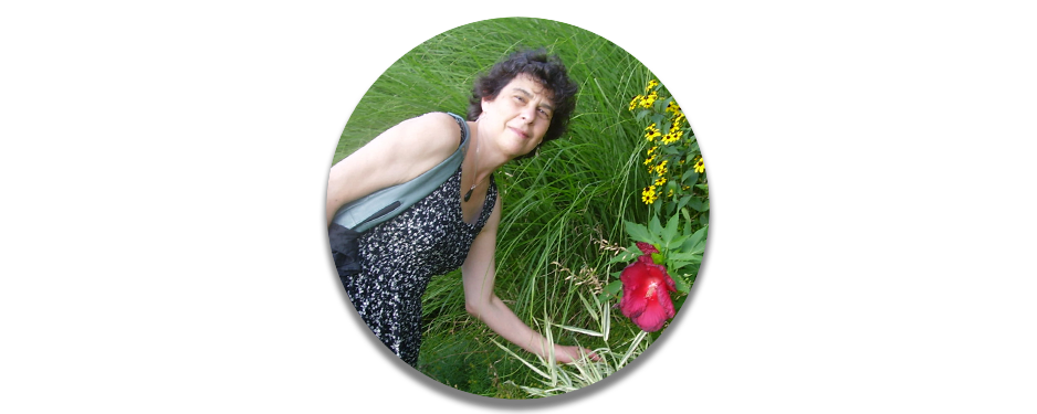 Former Executive Director, Karen Schwartz, stands with a large flower.