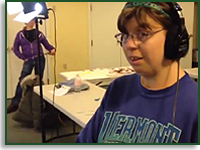 A screen capture of Speak Up Speaks out. A woman wears handphones as she captures audio for the show.