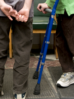 A student using cruches stands in line with their peers.